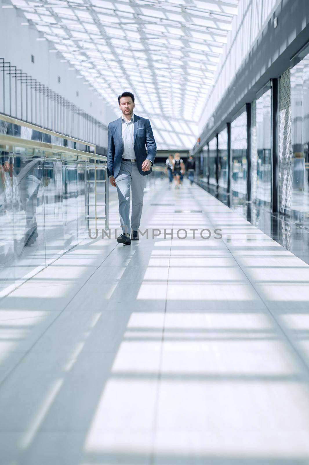 businessman walking in the airport building. the concept of business travel.