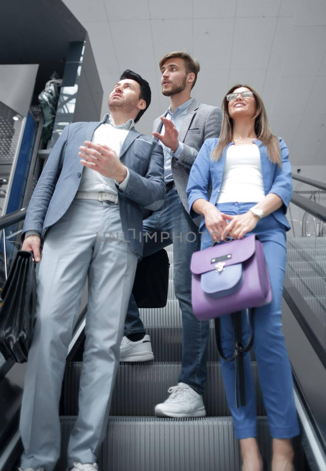 group of business people standing on the escalator and looking up.business concept