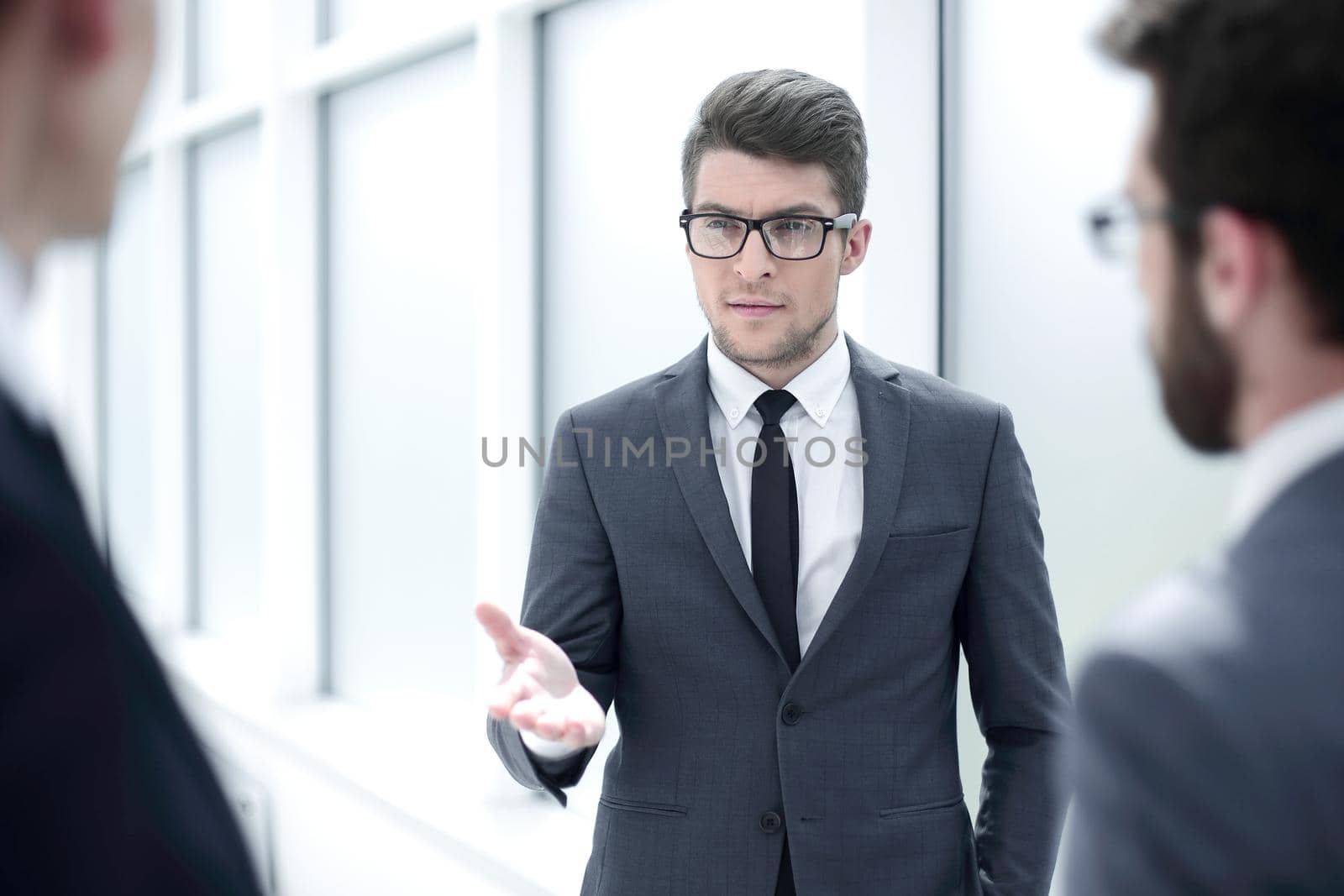 boss talking to employees standing in the office.business concept