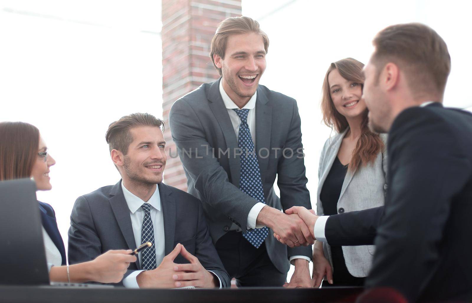 Confident businessmen sitting by table during consultation