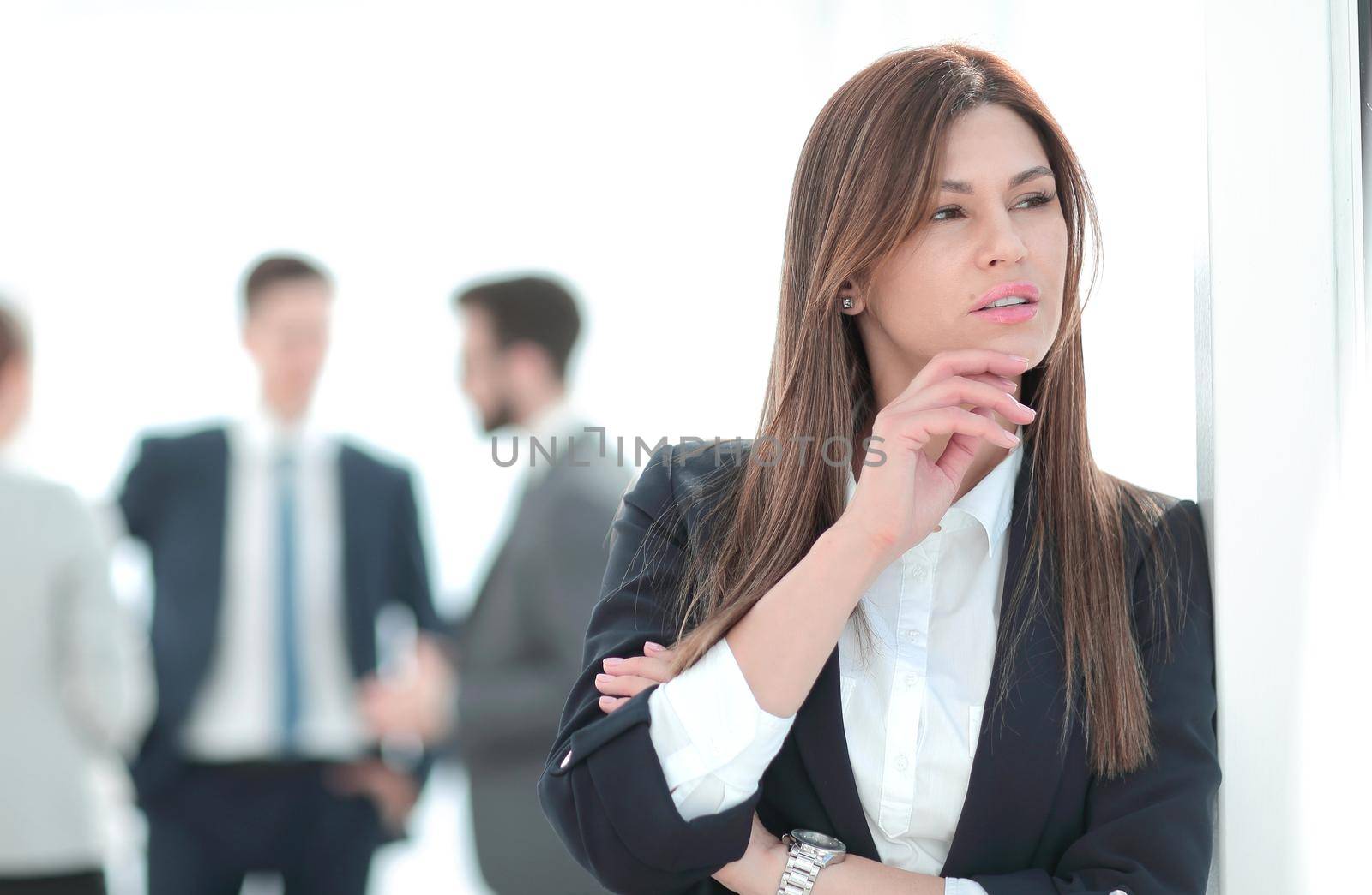 pensive business woman on blurred office background. photo with copy space