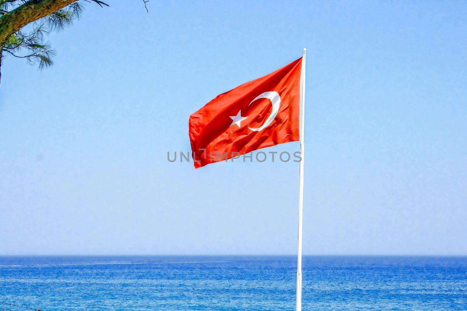 Turkey flag on the background of the sea and blue sky. In the summer while relaxing at sea.