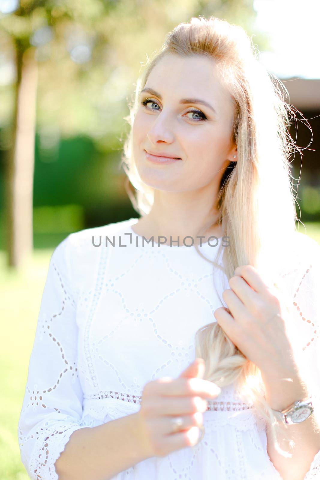 Portrait of young beautiful blonde woman wearing white clothes. by sisterspro