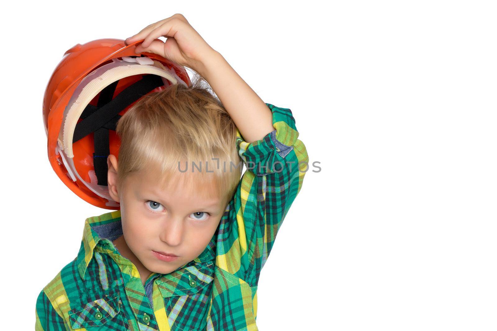 Little boy in construction helmet. The concept of professional development of a child at an early age. Isolated on white background.