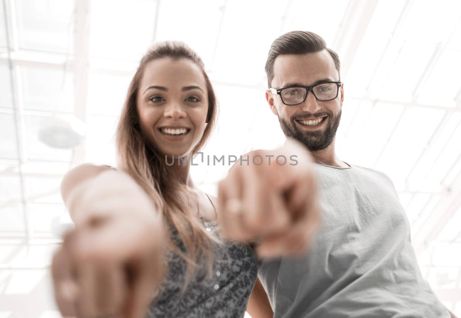 close up.happy couple pointing at you.photo with copy space