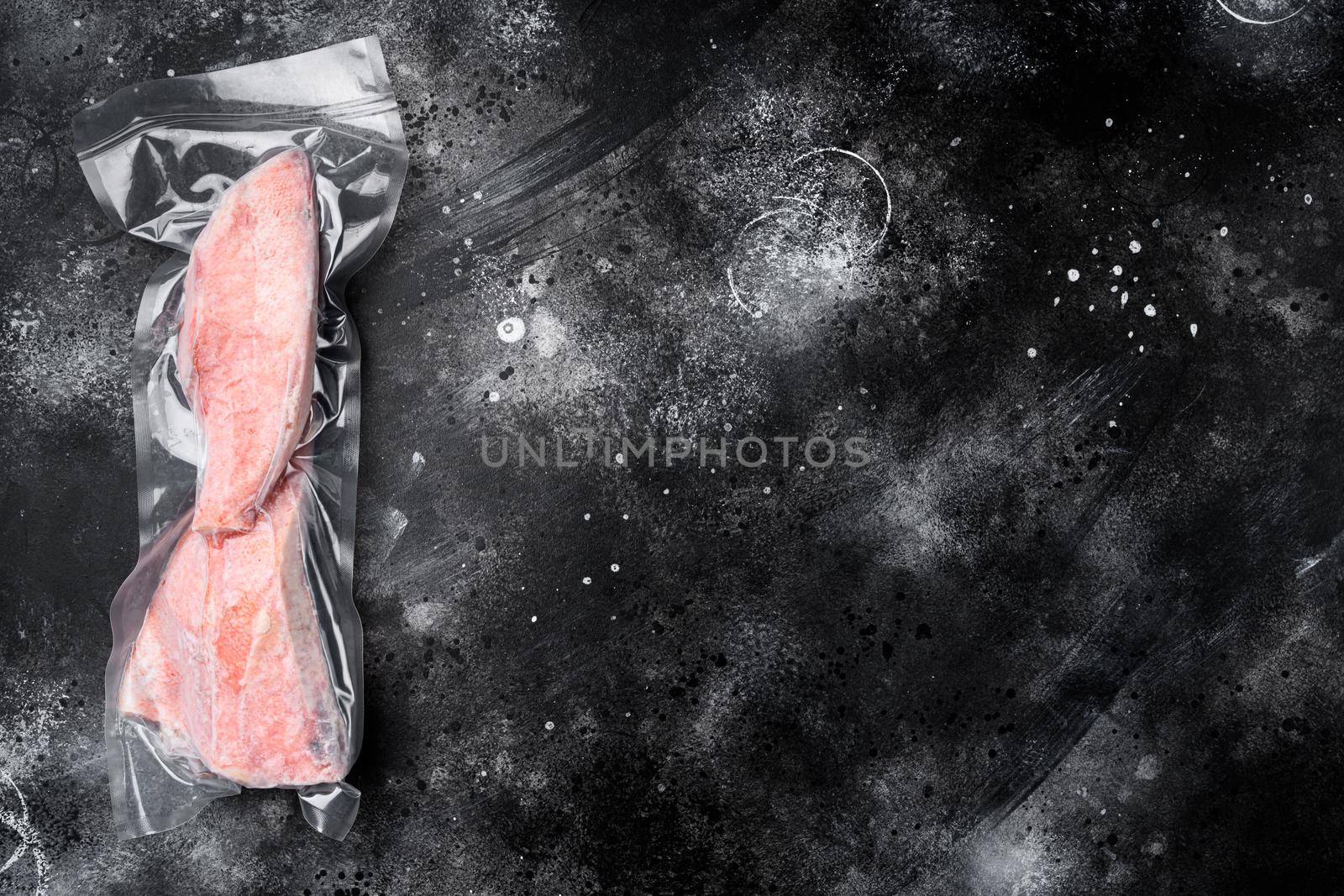 Red perch frozen pack fish meat set, on black dark stone table background, top view flat lay, with copy space for text