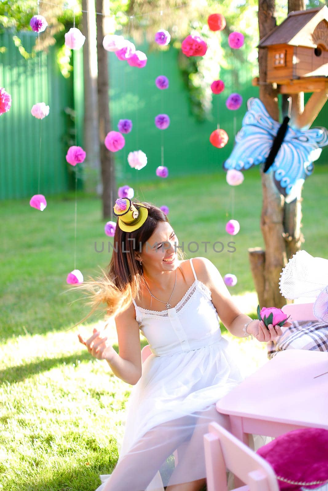 Young girl playing with bright decorations for summer camp.