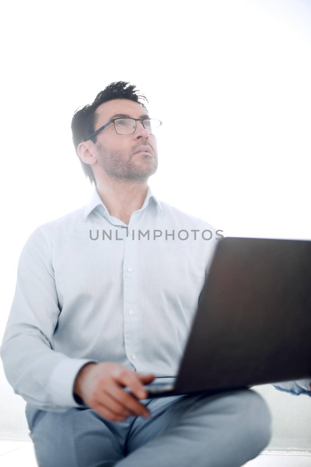 close up.serious businessman with a laptop. photo with copy space