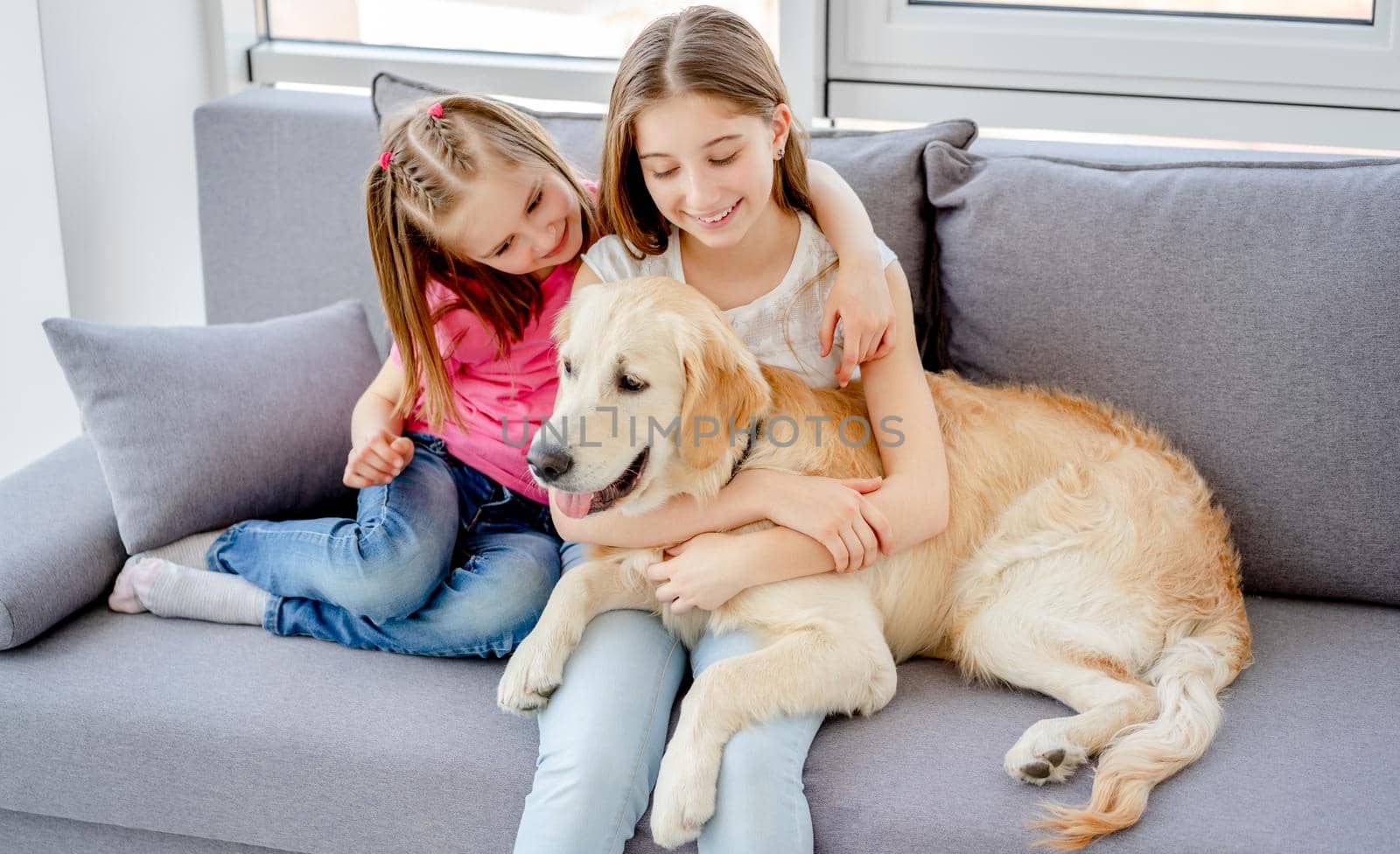 Smiling girls cuddling lovely dog by GekaSkr