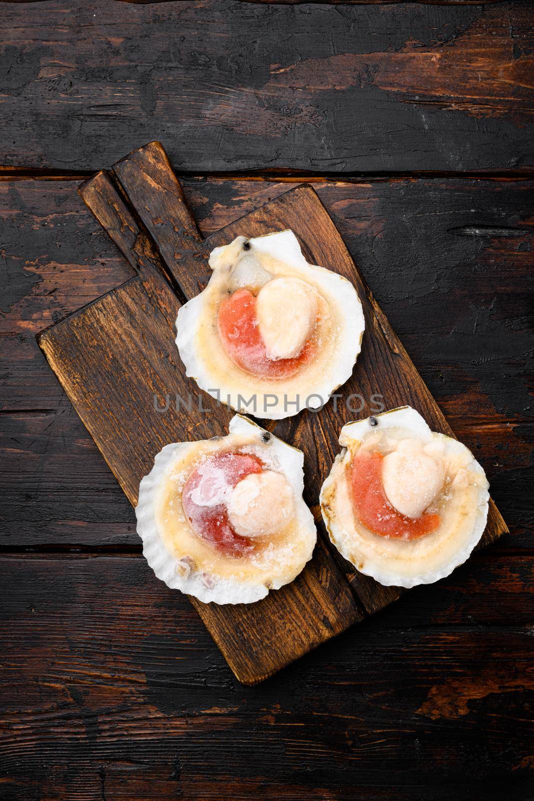 Shellfish, Frozen raw fresh scallops set, on old dark wooden table background, with copy space for text