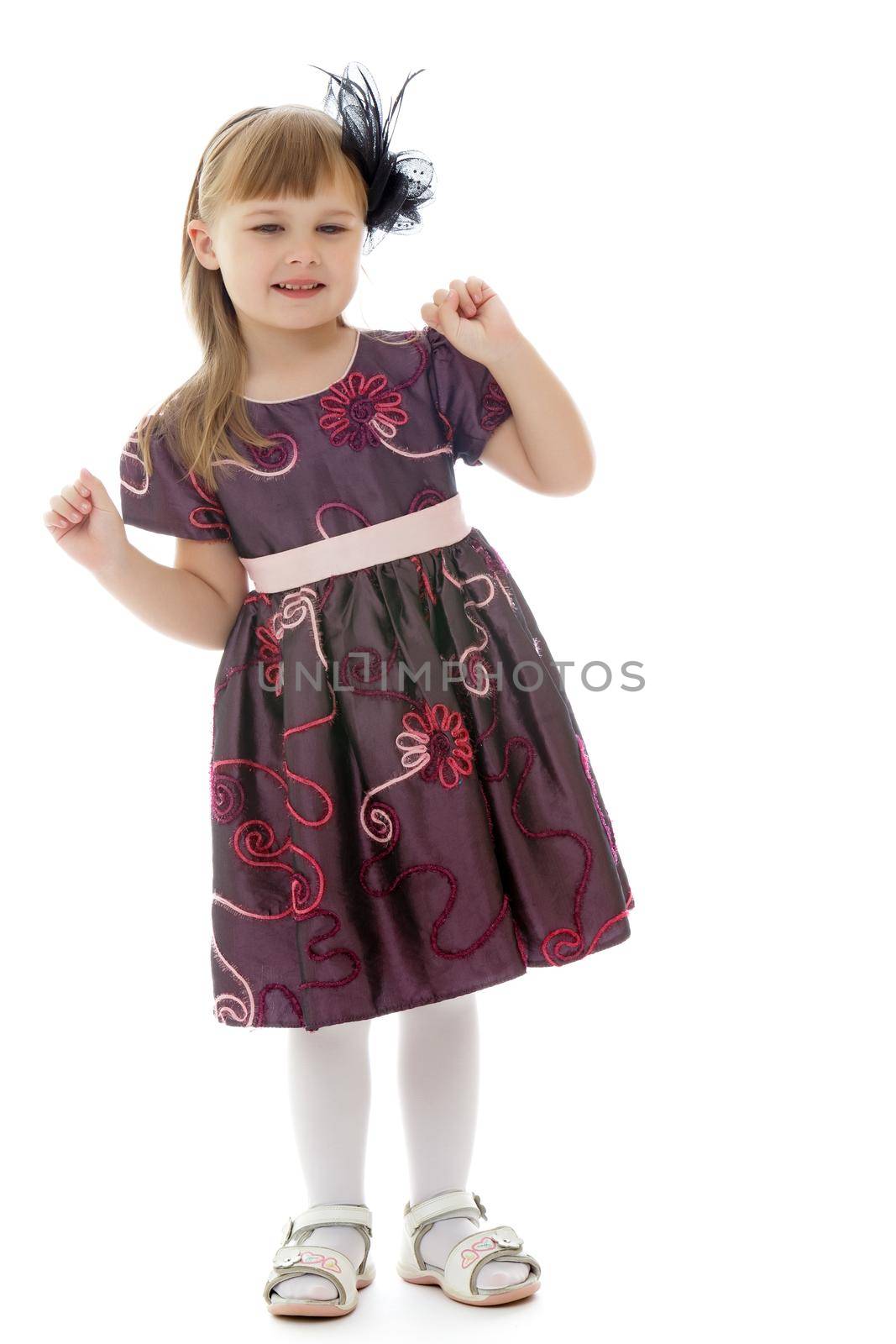 Beautiful little girl is having fun dancing in the studio on a white background. The concept of a school of dance, happy people. Isolated.