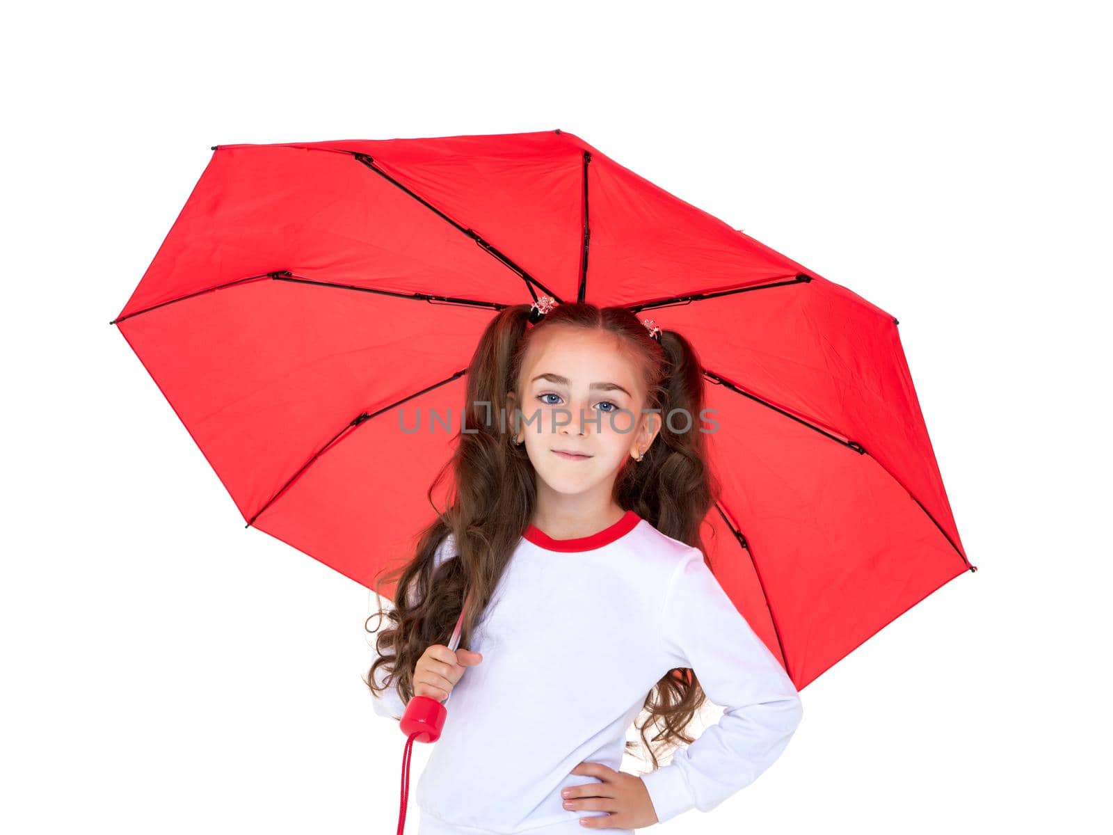 A beautiful little girl hid under an umbrella. The concept of summer vacation, style and fashion. Isolated on white background.