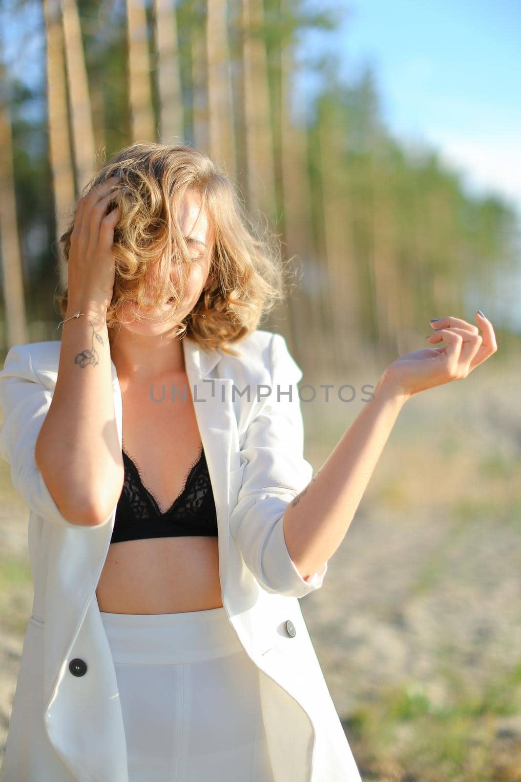 Caucasian happy girl walking on sand beach and wearing white shirt. by sisterspro