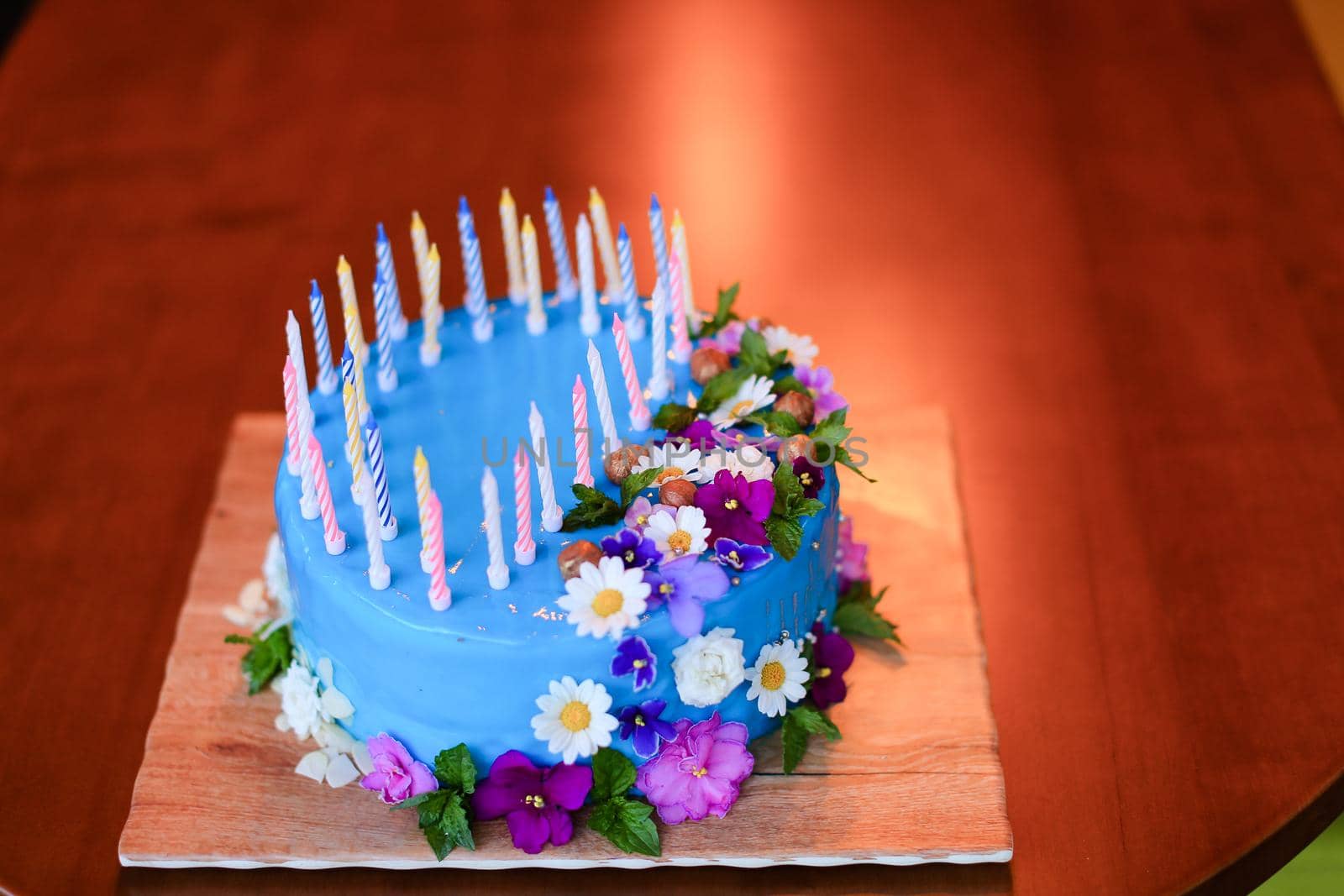 Blue isolated cake on wooden background with copy space. Concept of sweet food for birthday party.