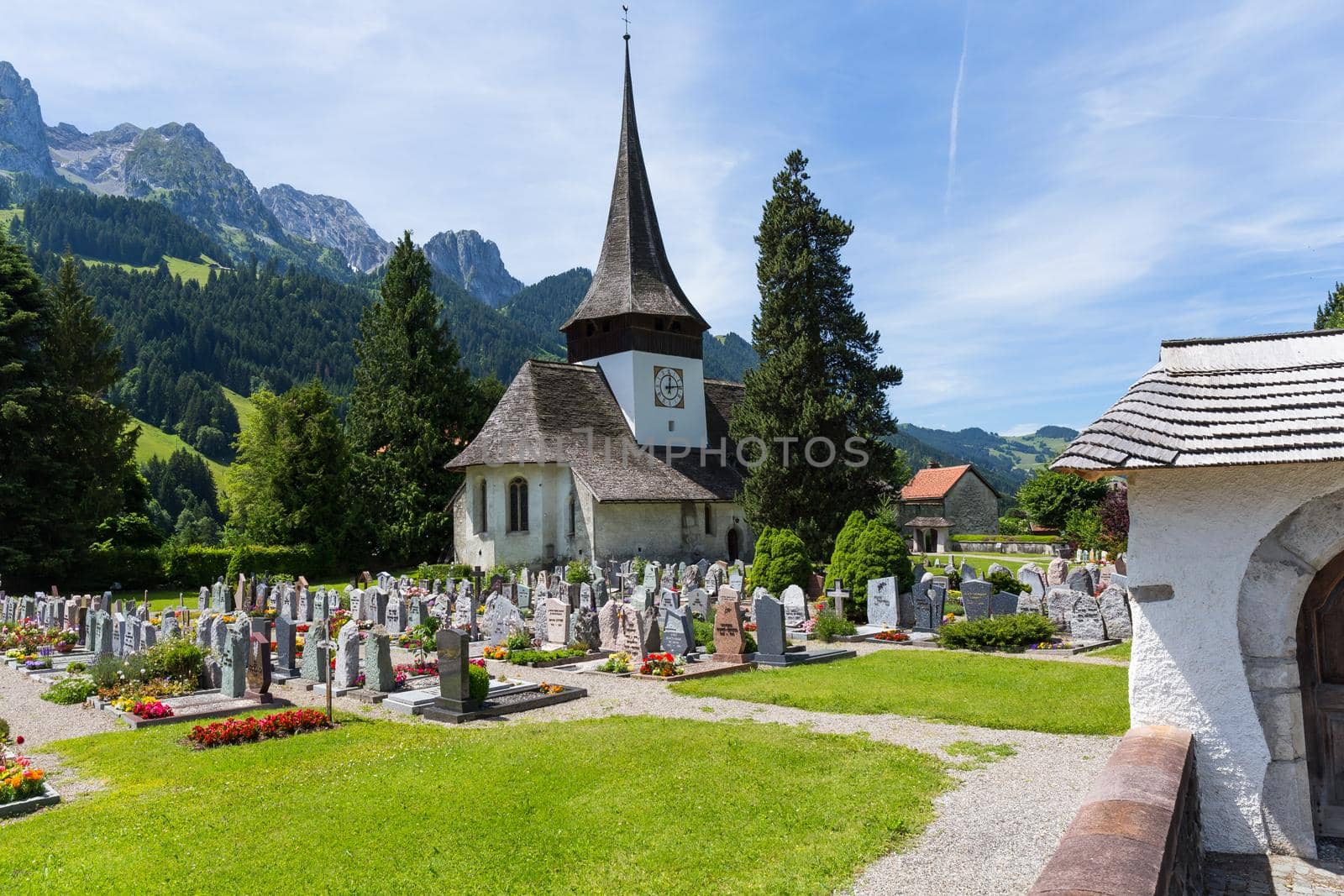 Church with wooden roof  and cemetery in Rougemont Vaud canton of Switzerland