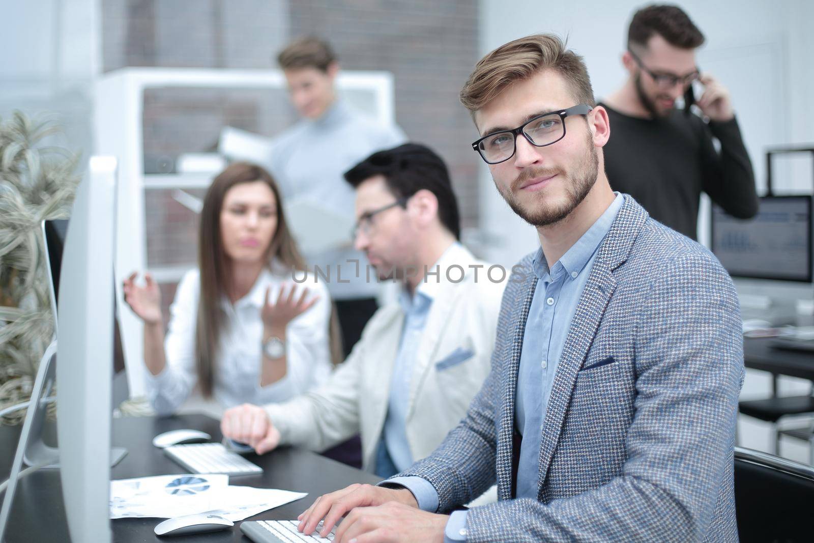 businessman sitting at his Desk by asdf