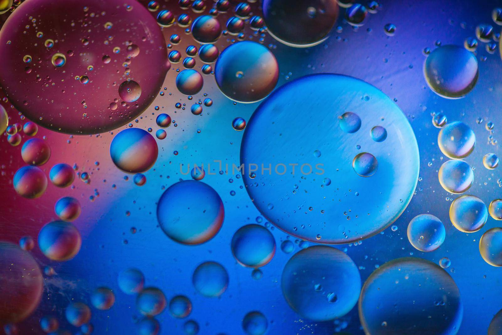 Multicolored abstract defocused background picture made with oil, water and soap by anytka