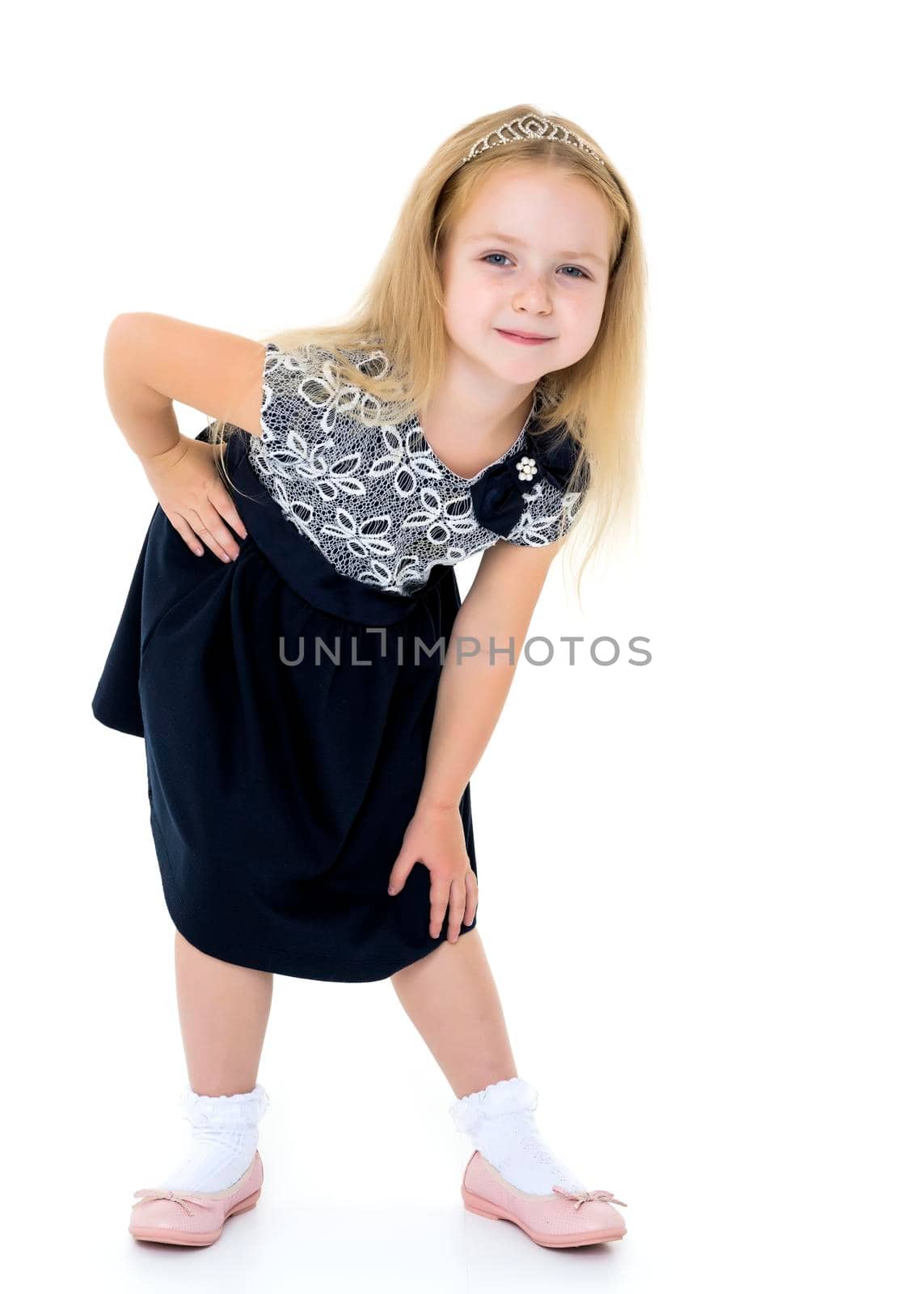 Beautiful little girl posing in the studio on a white background. The concept of style and fashion. Isolated on white background.