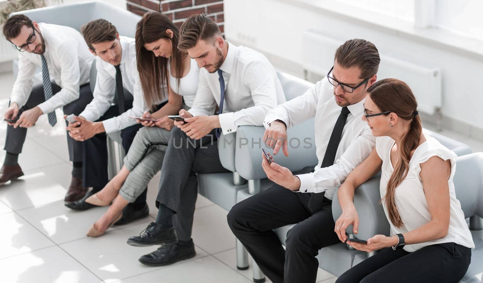 business team sitting in the lobby of the business center .business concept