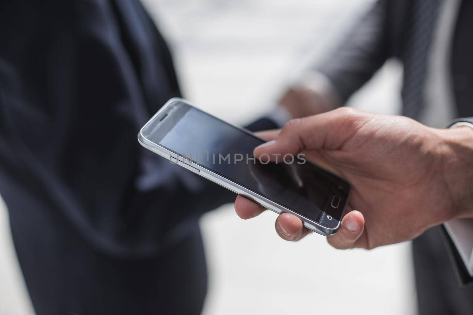 close up.businessman reading text message on smartphone.business concept