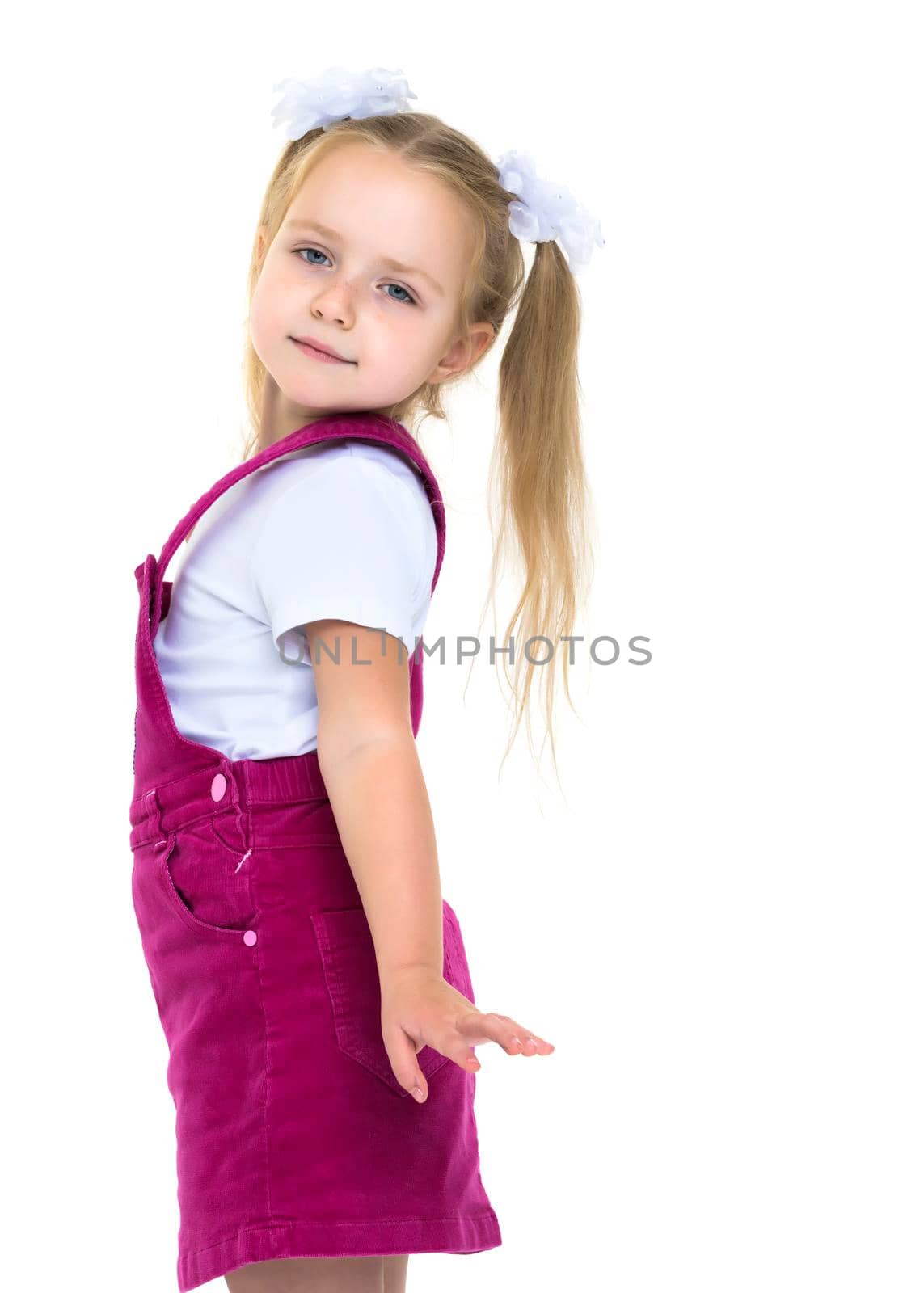 Beautiful little girl posing in the studio on a white background. The concept of style and fashion. Isolated on white background.