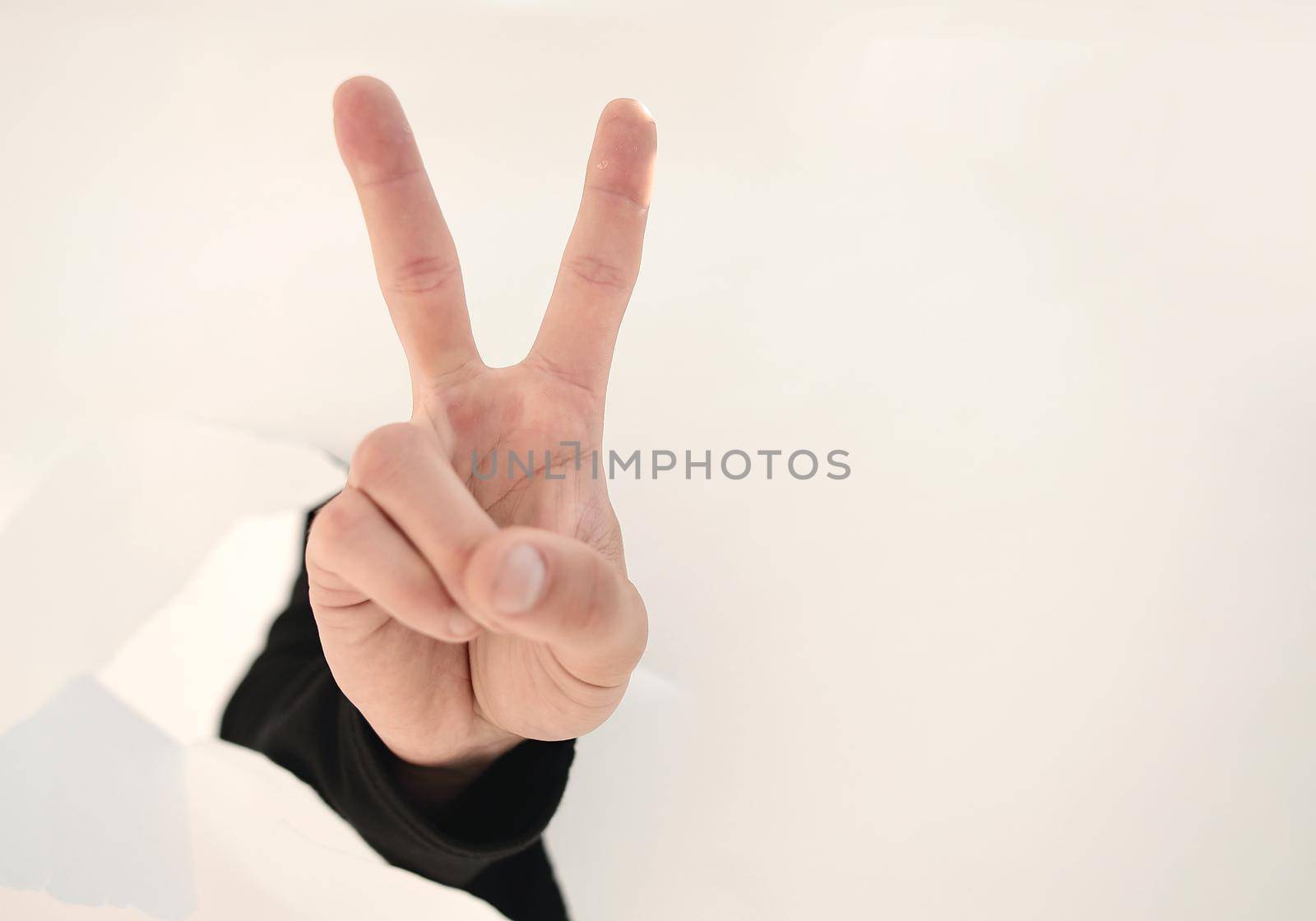 close up.businessman showing his index finger through the torn paper.photo with copy space