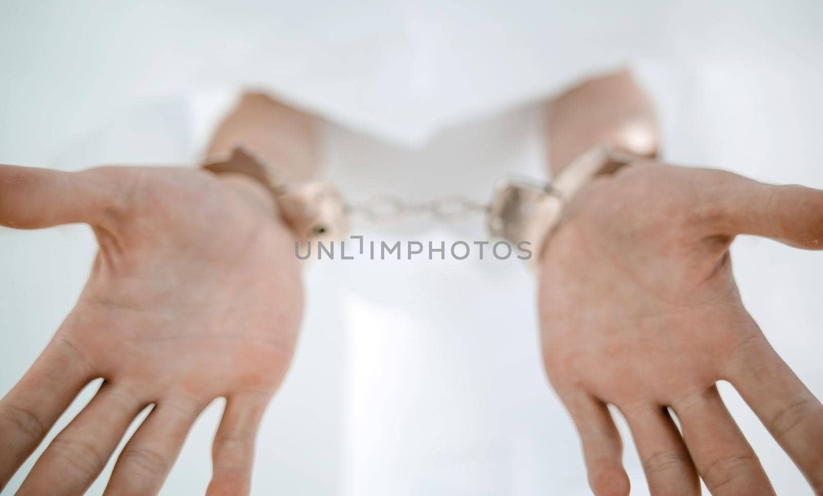 close up.man showing his hands handcuffed.photo with copy space