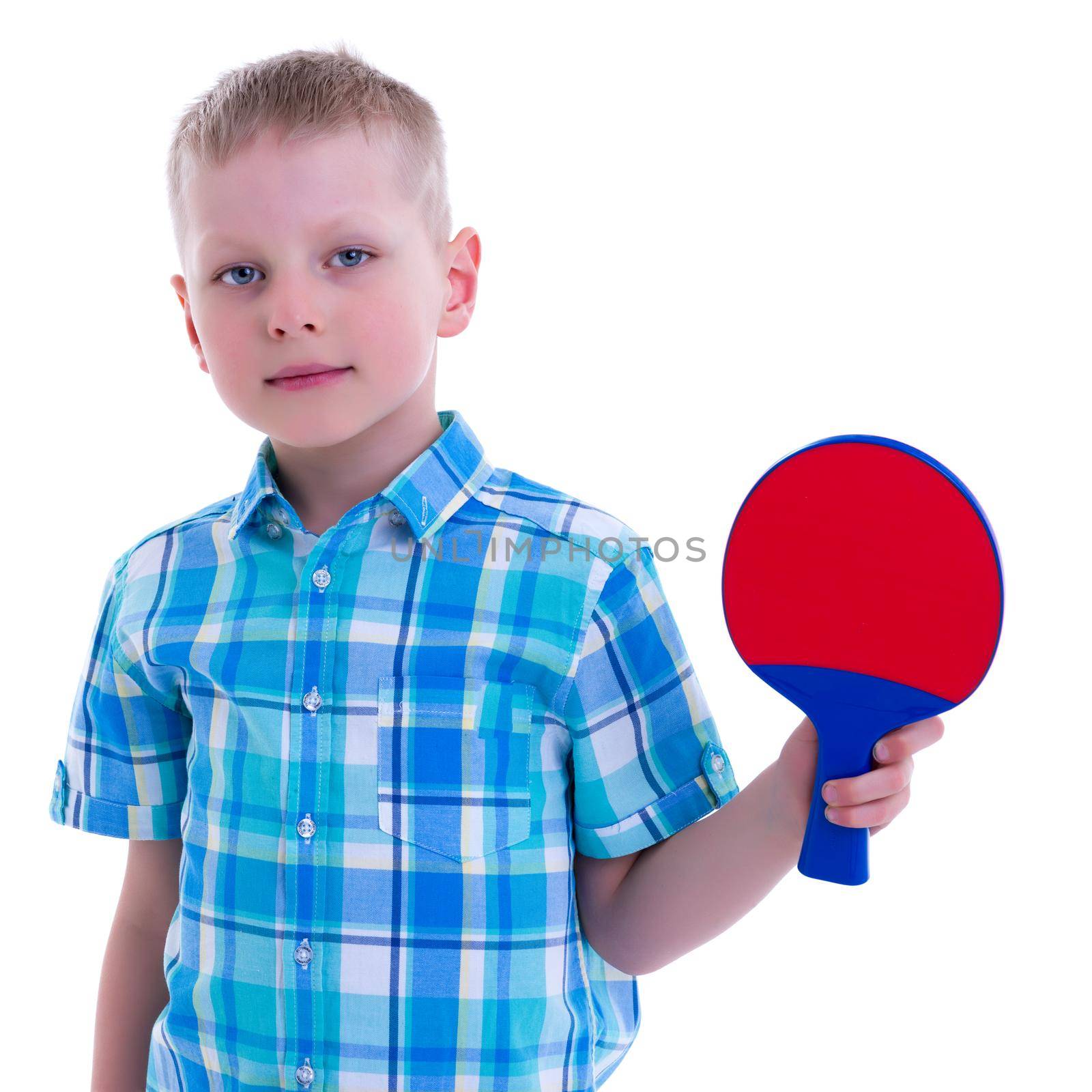 Cute little boy with a ping pong racket. The concept of children's sports.