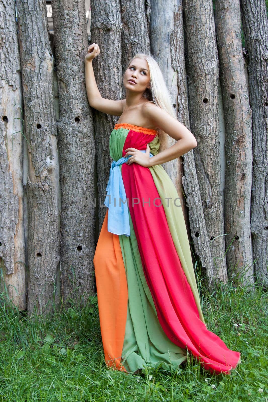 Sexy woman outdoor with nice colorful dress. Fashion