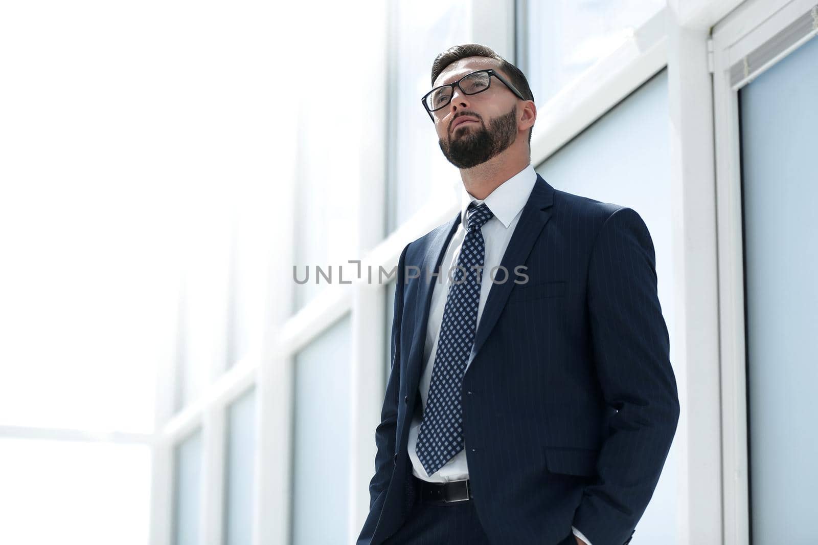 serious businessman standing in a spacious office.photo with text space