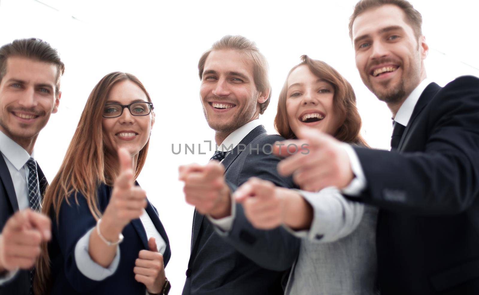Happy business group poiting at the camera
