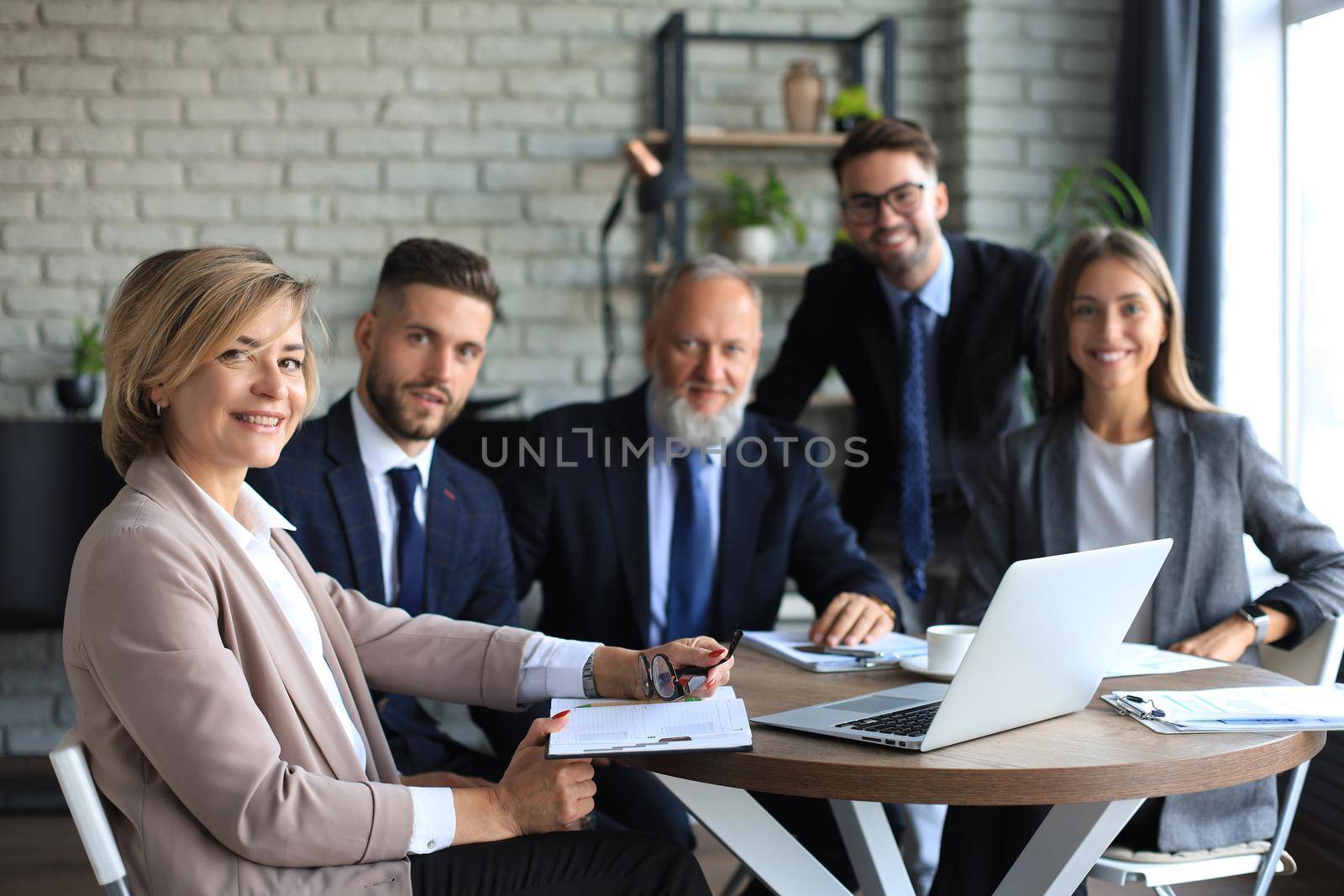 Portrait of a positive business employees at an office business meeting. by tsyhun