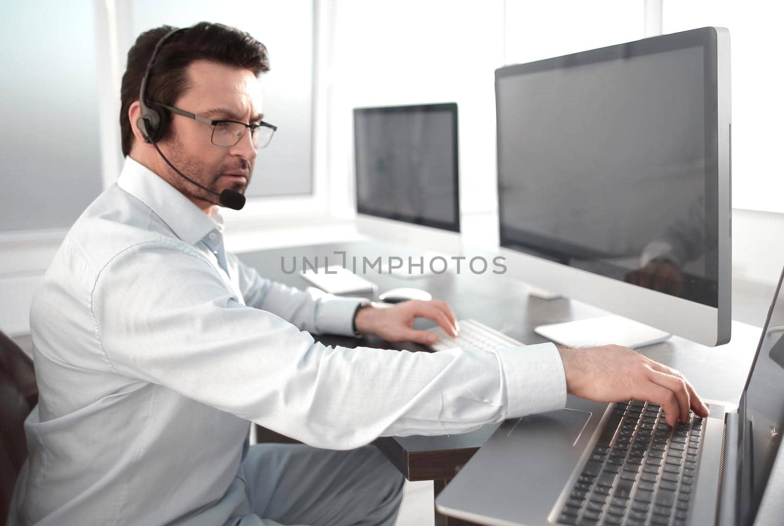 business center employee sitting at his Desk.the concept of e-business