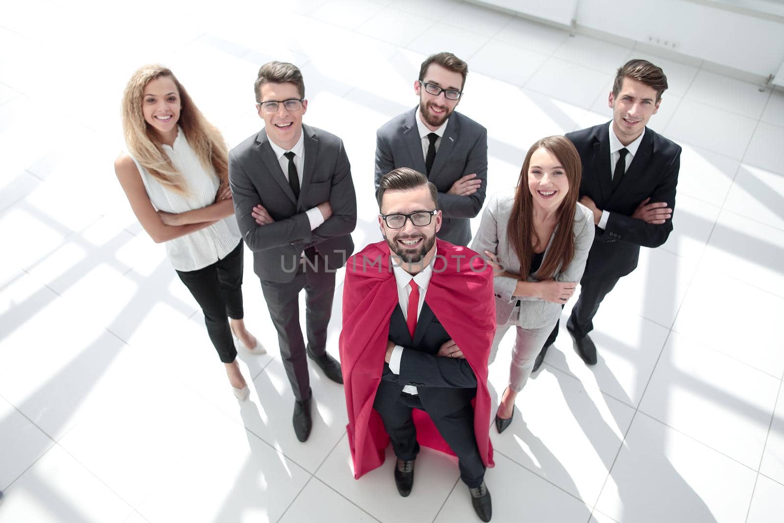 top view.businessman-Superman and his business team standing together.business concept