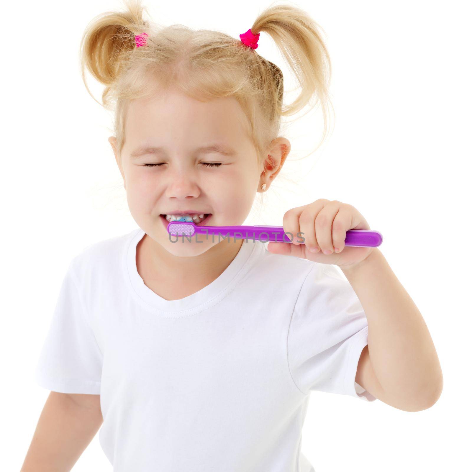 A little girl brushes her teeth. by kolesnikov_studio