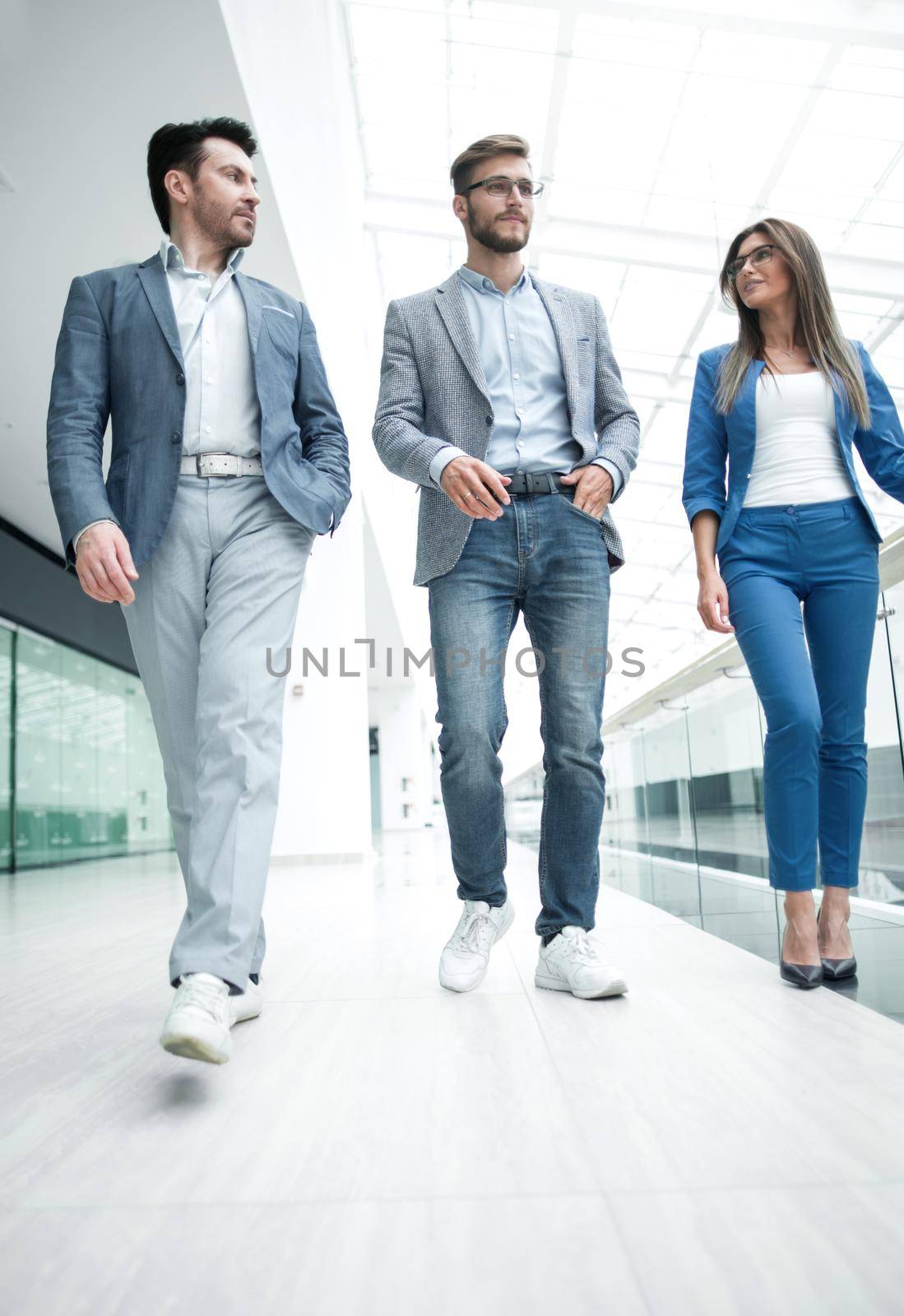 group of business people in the office hall by asdf