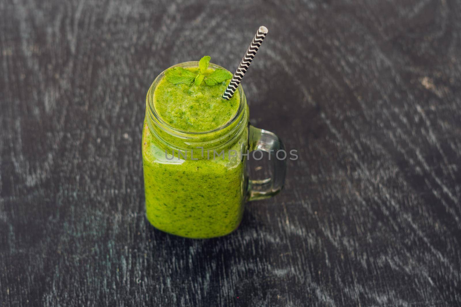 Green smoothies made of spinach. Healthy eating and sports concept by galitskaya
