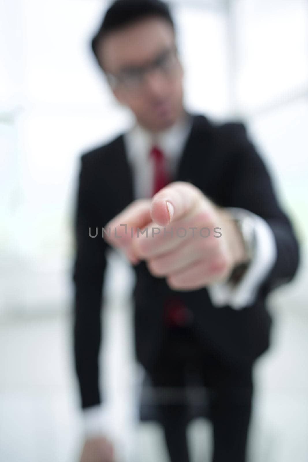 background image of a businessman pointing his finger at you.business concept