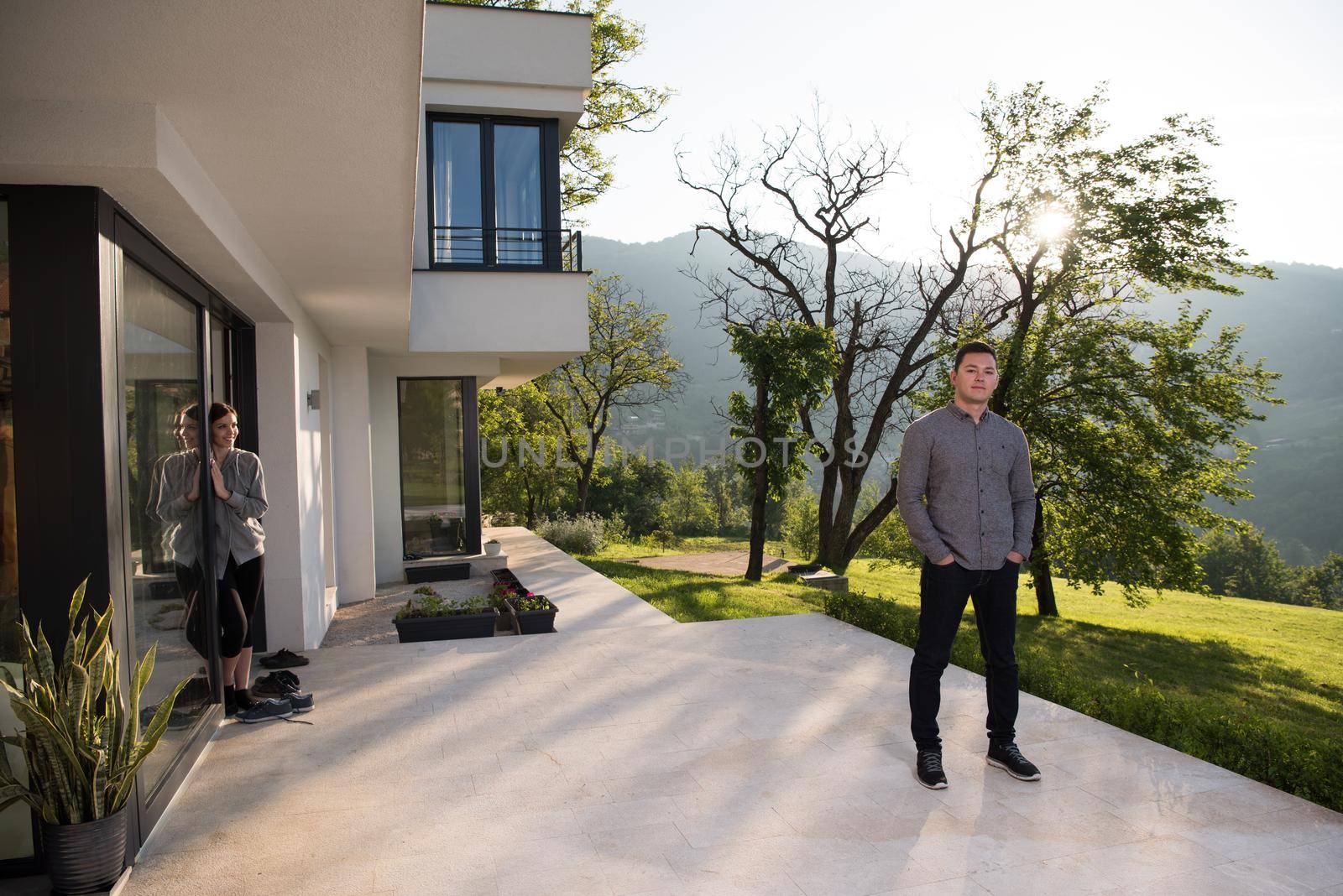 man in front of his luxury home villa by dotshock
