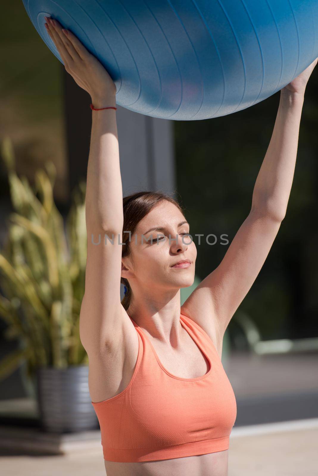 woman doing exercise with pilates ball by dotshock