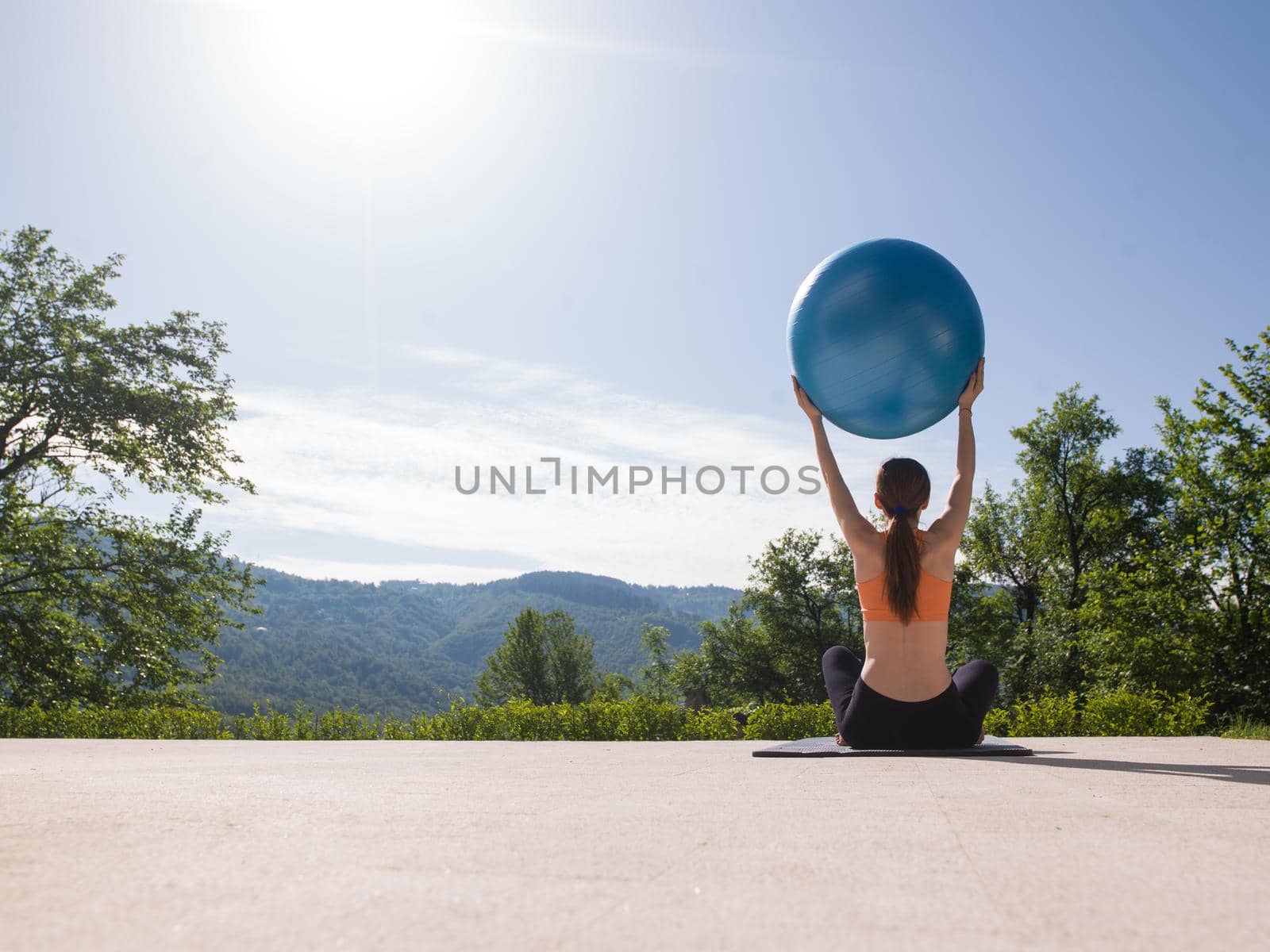 woman doing exercise with pilates ball by dotshock