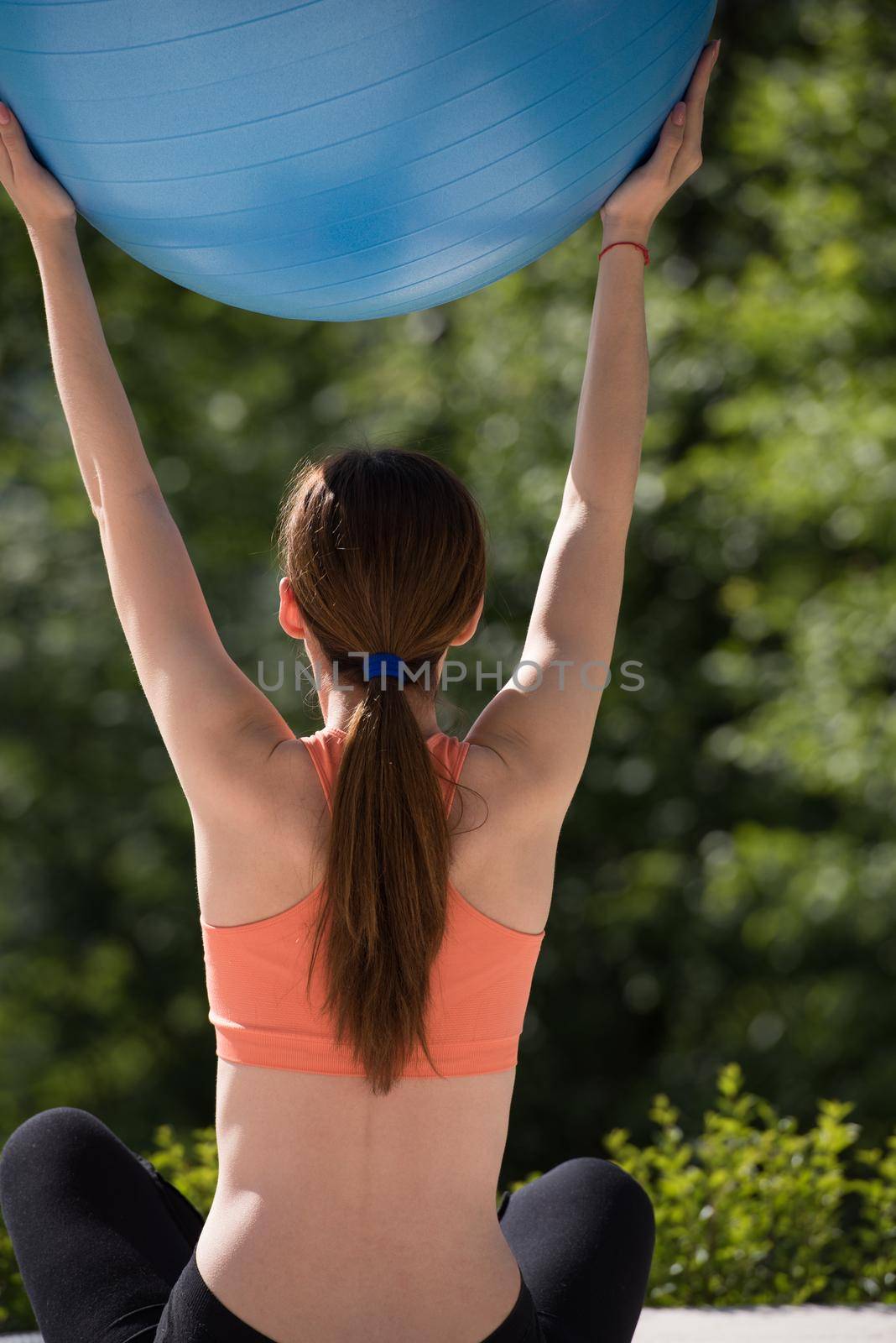 woman doing exercise with pilates ball by dotshock
