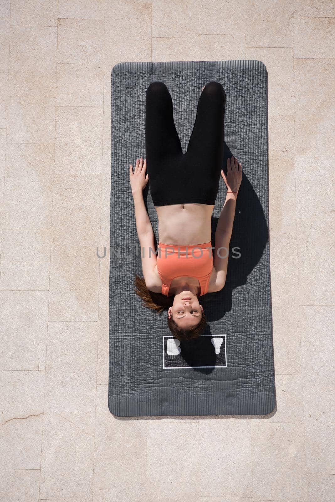 woman doing morning yoga exercises top view by dotshock