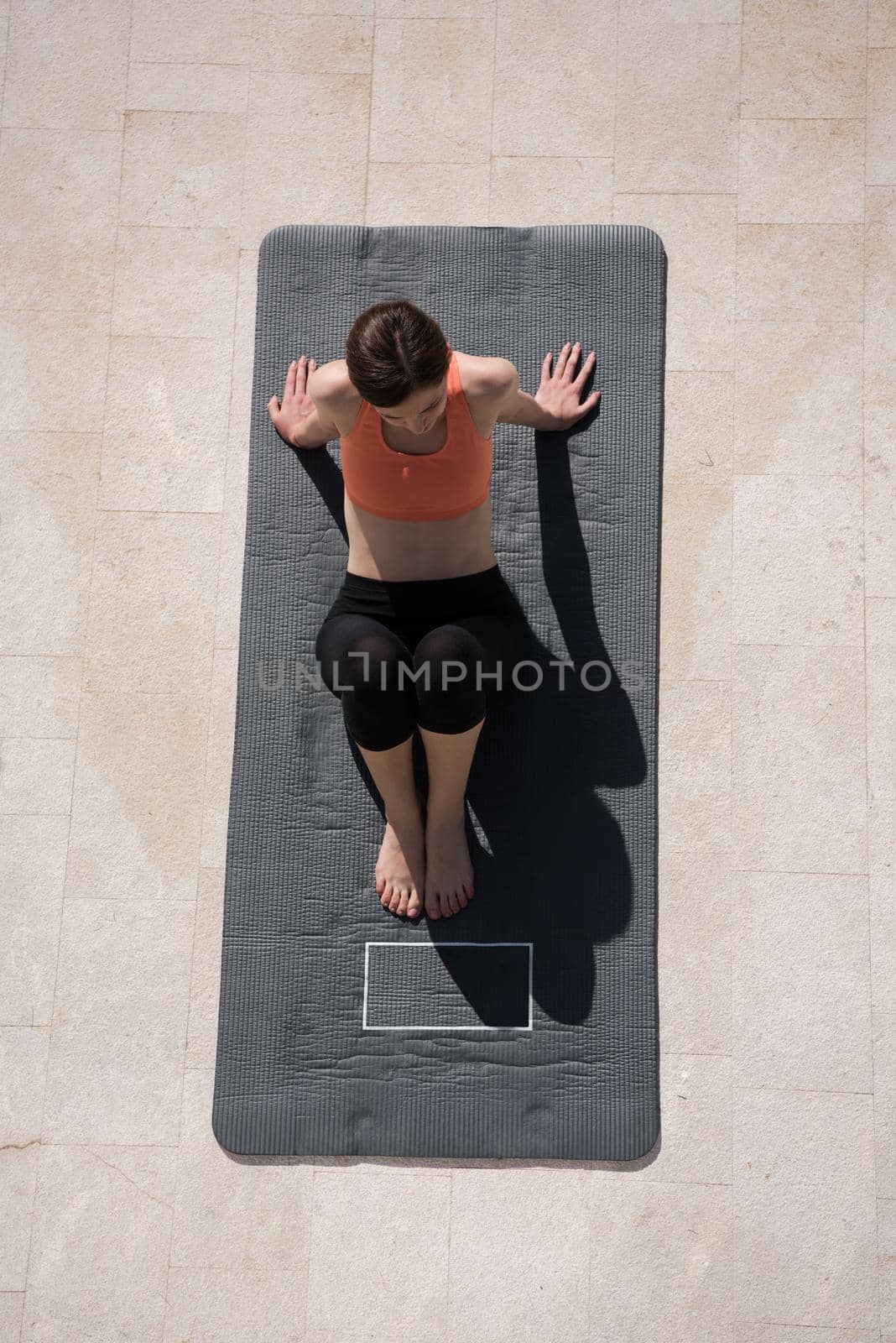 woman doing morning yoga exercises top view by dotshock