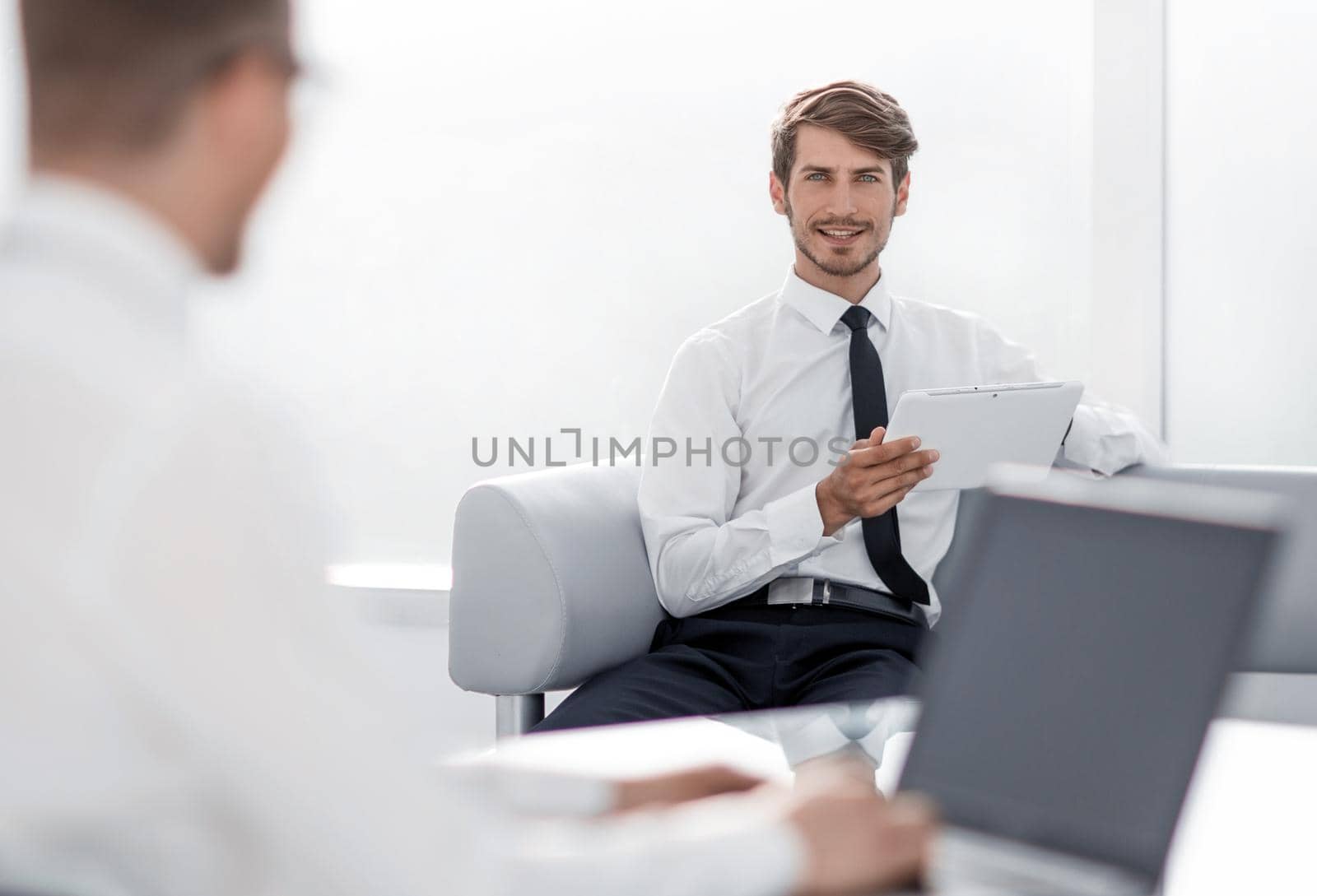 Two businessmen negotiating sitting at table, business partners working together, preparing business offer