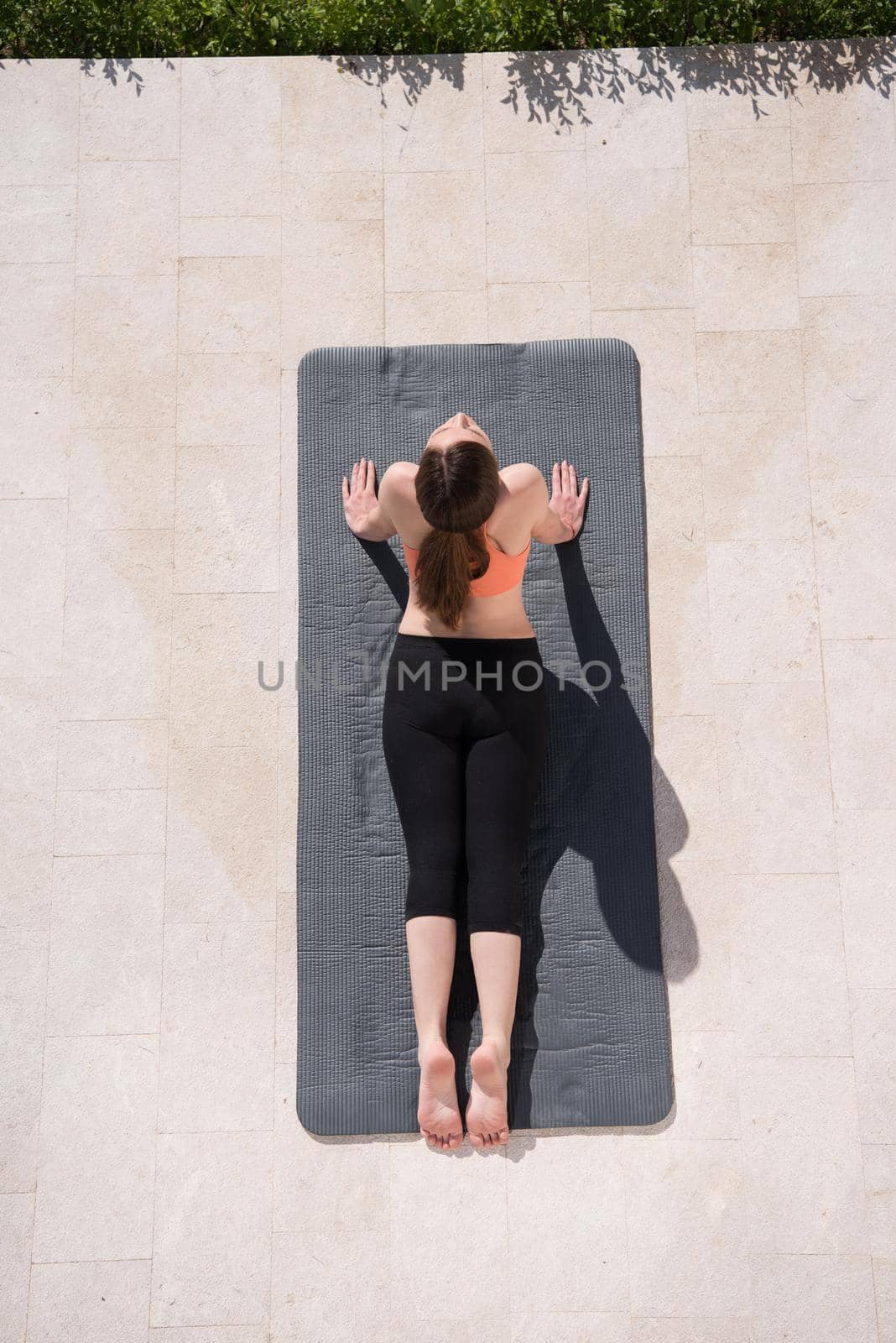 woman doing morning yoga exercises top view by dotshock