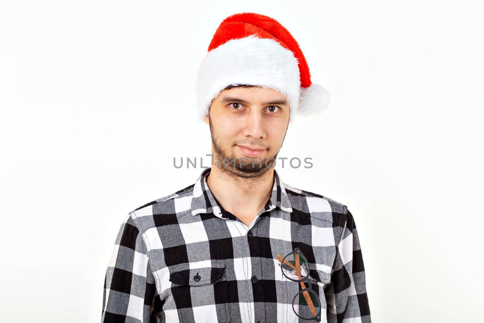 Holidays and presents concept - Funny man in Christmas hat on white background with copyspace.