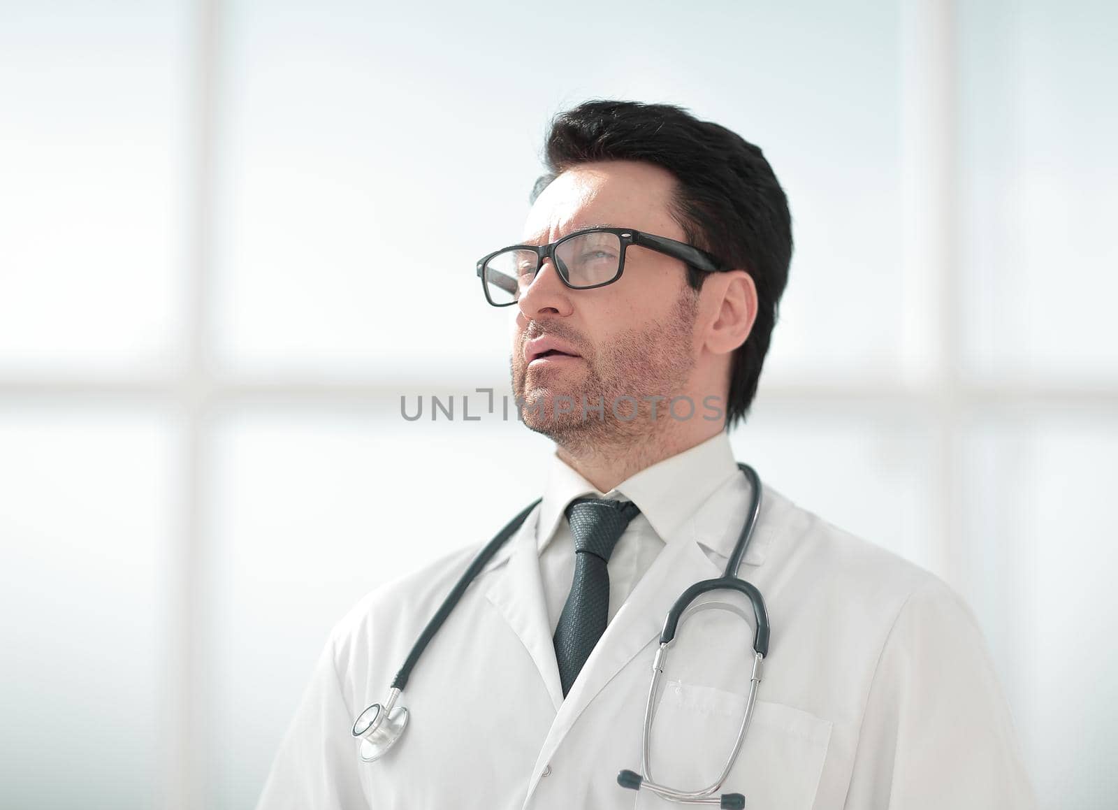 serious doctor on the background of a bright room .photo with text space