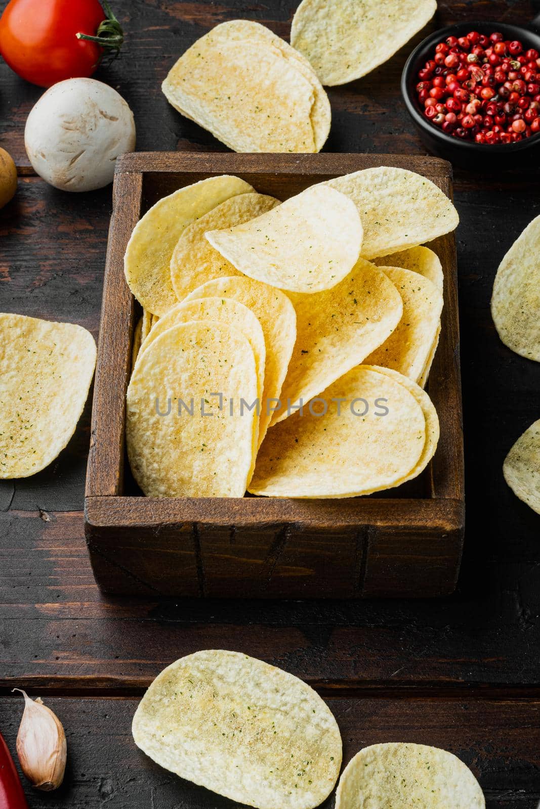 Delicious crispy potato chips set, on old dark wooden table