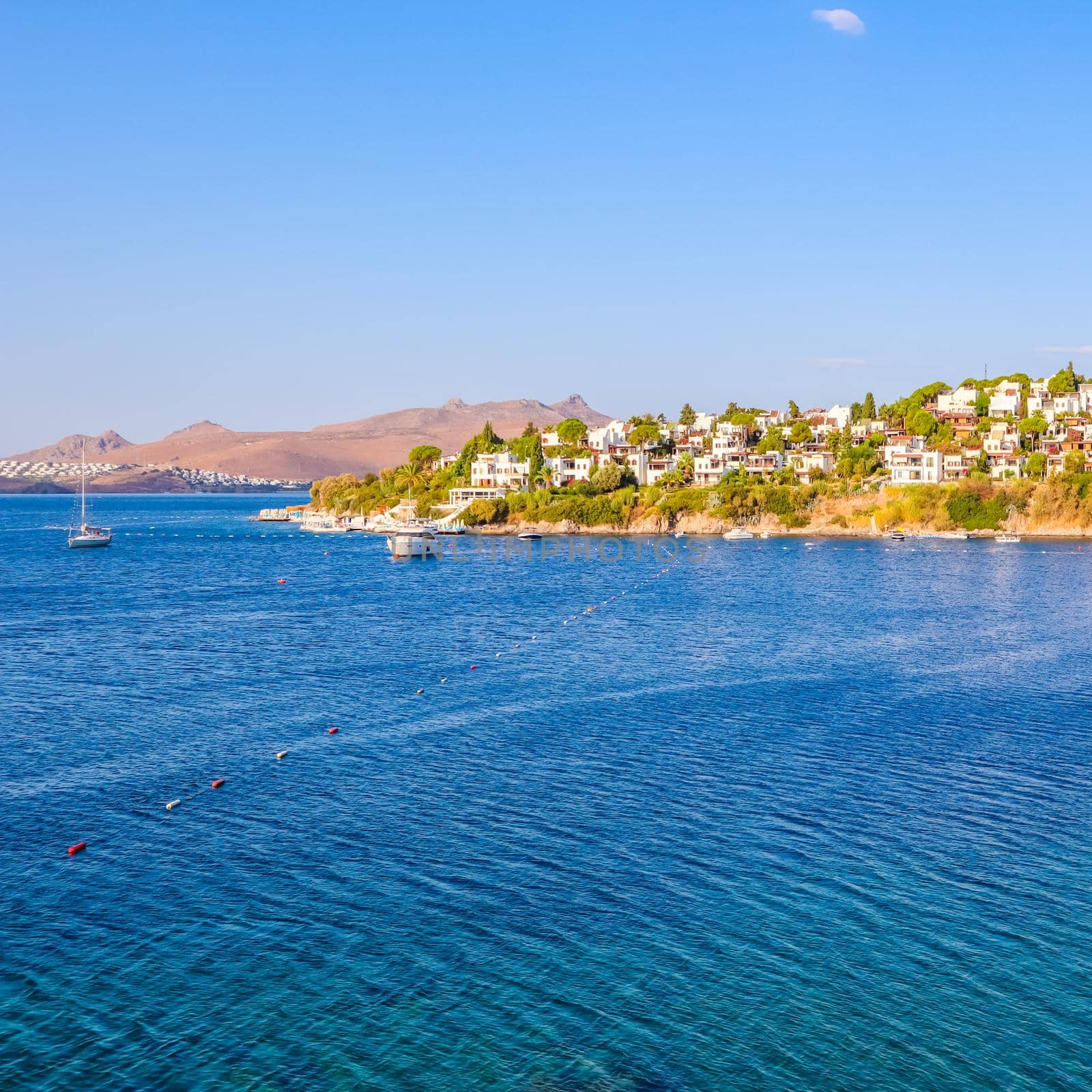 Aegean coast with marvelous blue water, rich nature, islands, mountains and small white houses